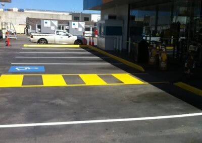 Pedestrian Line Marking in yellow outside a shopping area.